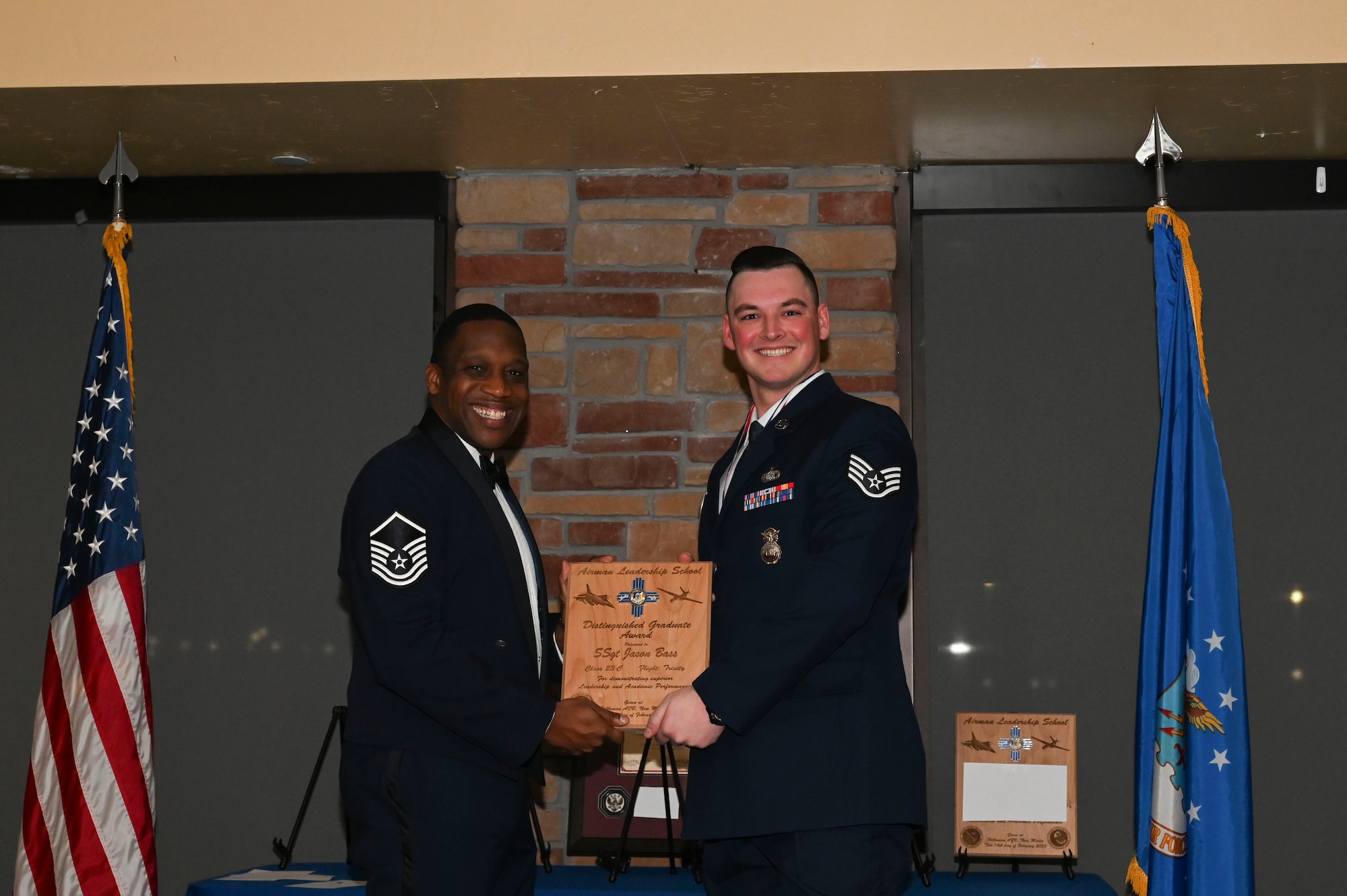 Staff Sgt. Jason Bass, Detachment 3 Security Forces Squadron, Airman Leadership School graduate, accepts the distinguished graduate award during the graduation of ALS class 23-C at Holloman Air Force Base, New Mexico, Feb. 16, 2023. The distinguished graduate award is presented to the top ten percent of graduates for their performance in academic evaluations and demonstration of leadership. (U.S. Air Force photo by Airman 1st Class Isaiah Pedrazzini)