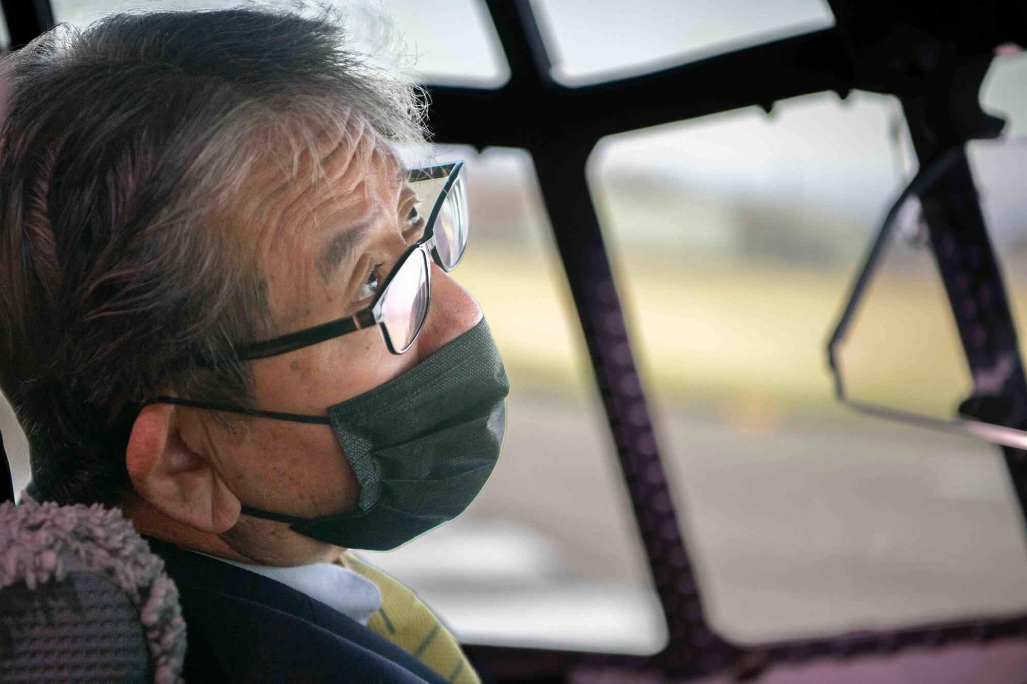 Hirotaka Hashimoto, Mayor of Hamura City, Japan, listens to instructions on how to pilot C-130J Super Hercules simulator before takeoff during a community engagement event at Yokota Air Base, Japan, Feb. 17, 2023.