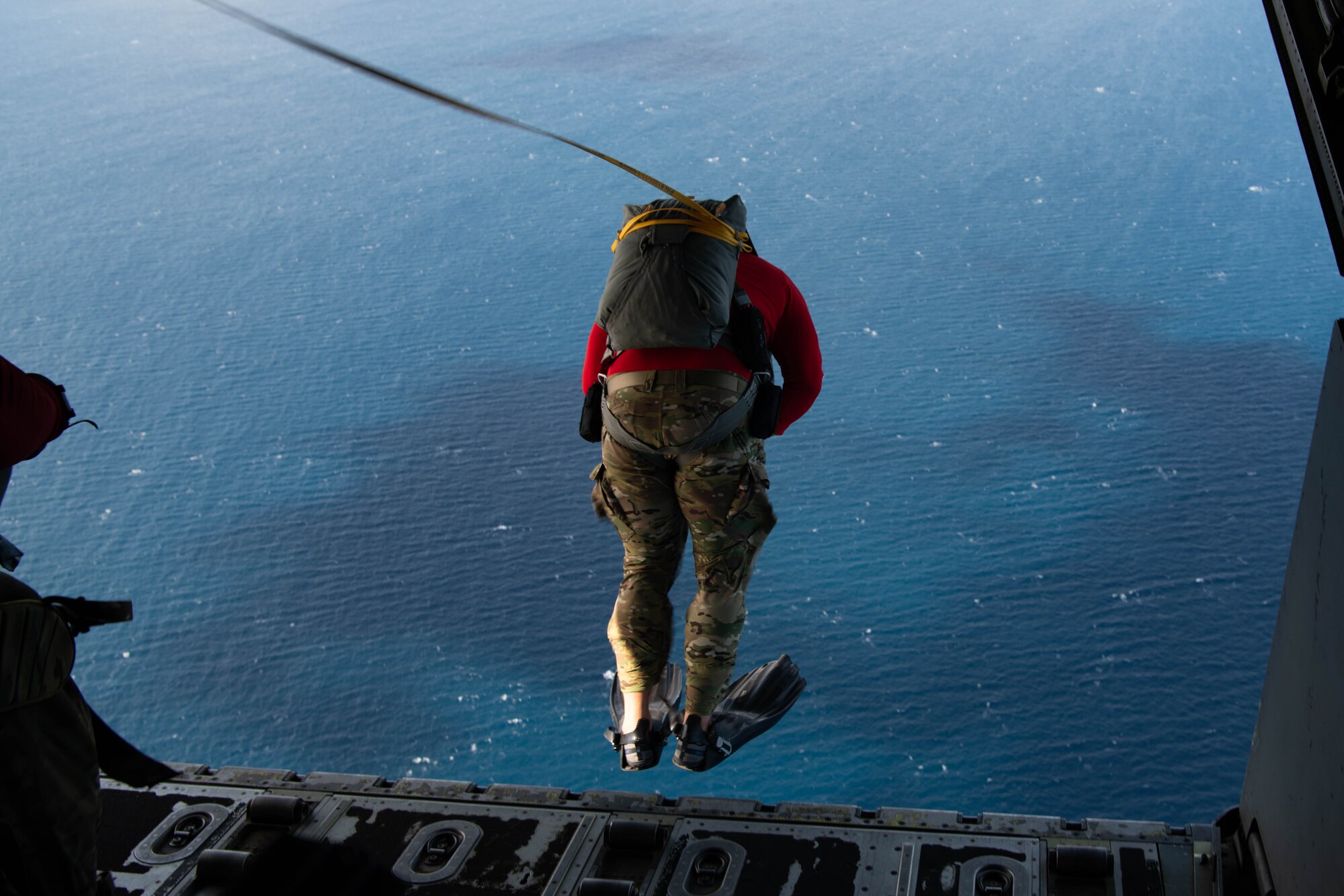An Airman jumps from an aircraft.