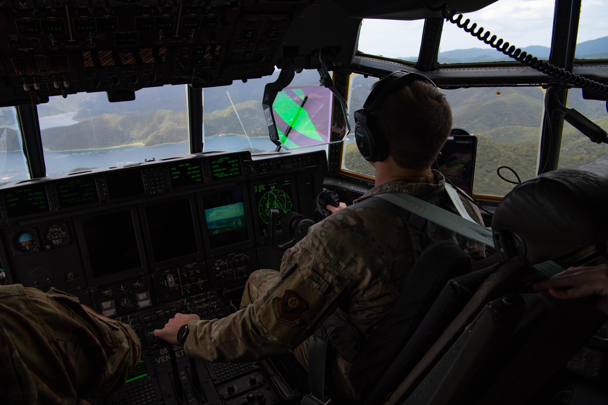 An Airman pilots an aircraft.