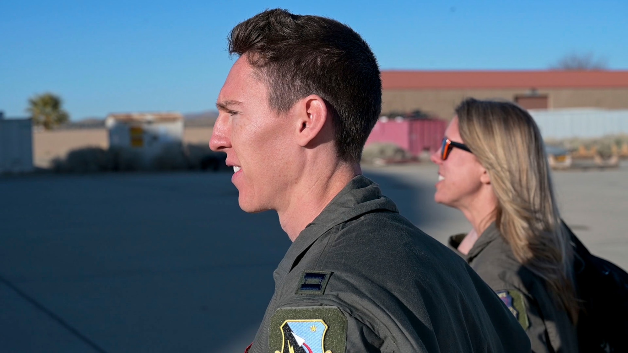 Capt. Layne Barrett, Student, USAF Test Pilot School and Jessica Peterson, Technical Director, 412th Operations Group walk out to the C-12 Huron to begin the Airborne Test Conduct event. This event, instructed on the C-12 Cargo aircraft, is the first event at USAF TPS where students are instructed on the use of basic test conduct tools such as test cards, a communication plan and collection of flight data.