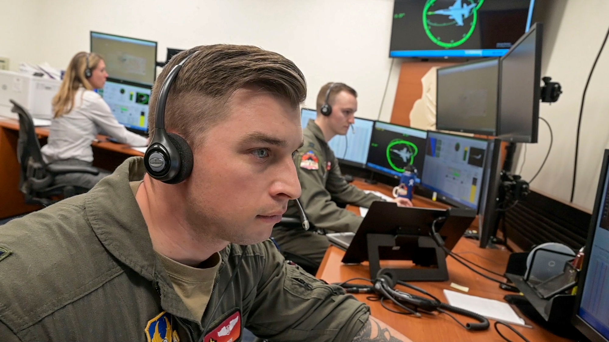Capt. Bobby Torick, Student, USAF Test Pilot School reads flight data in a control room at USAF Test Pilot School. The F-16 High Angle-of-Attack event, conducted around the 8th month of USAF TPS, is an event where the students design, rehearse and execute a plan that is representative of “real” flight test coordinating with the pilots.