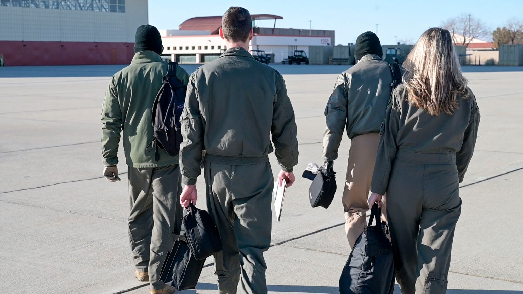 USAF Test Pilot School Flight Test Engineers walk out to the C-12 Huron to begin the Airborne Test Conduct Event. The Airborne Test Conduct event, instructed on the C-12 Cargo aircraft, is the first event at USAF TPS where students are instructed on the use of basic test conduct tools such as test cards, a communication plan and collection of flight data