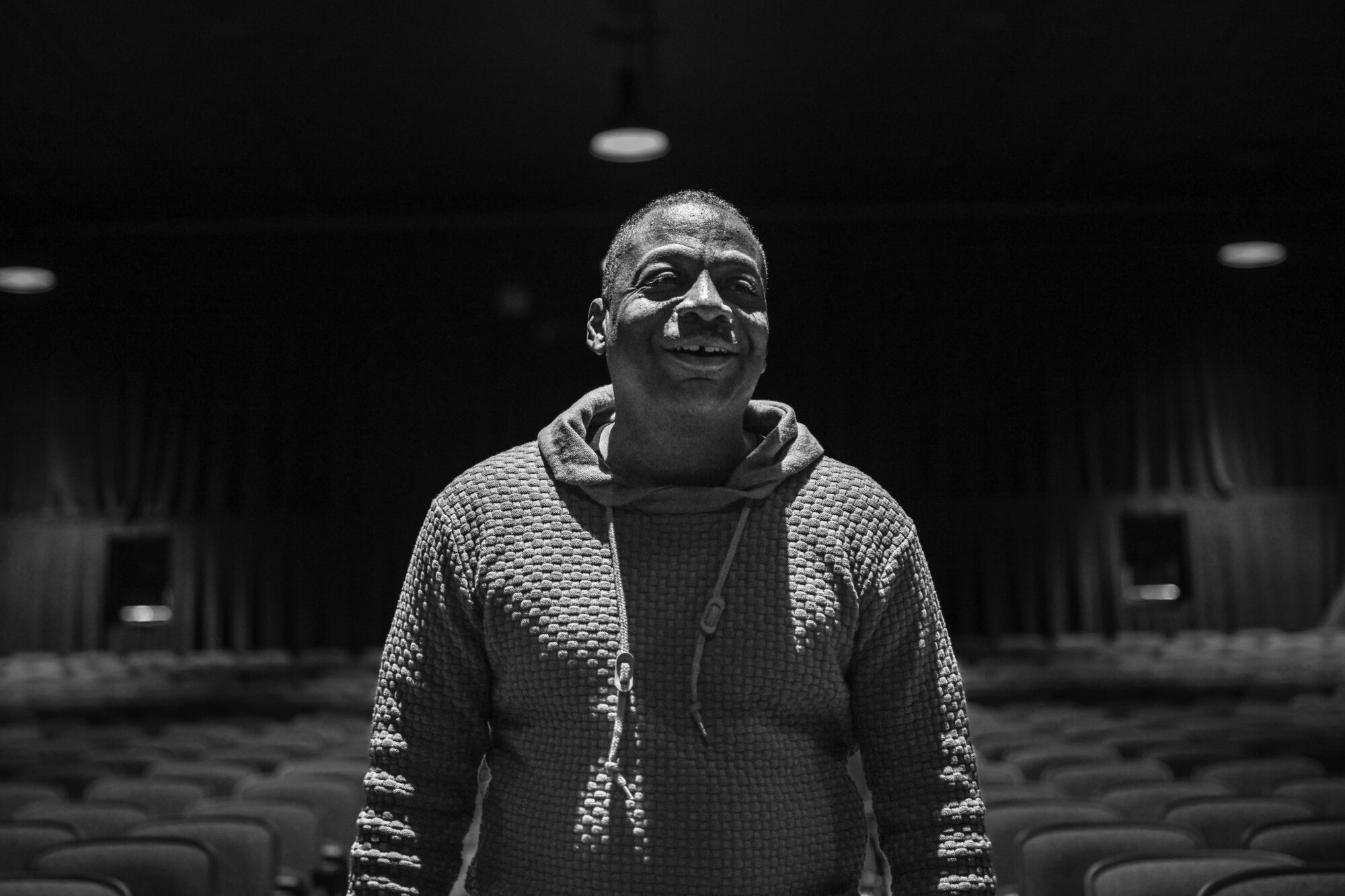 man poses for a black and white photo