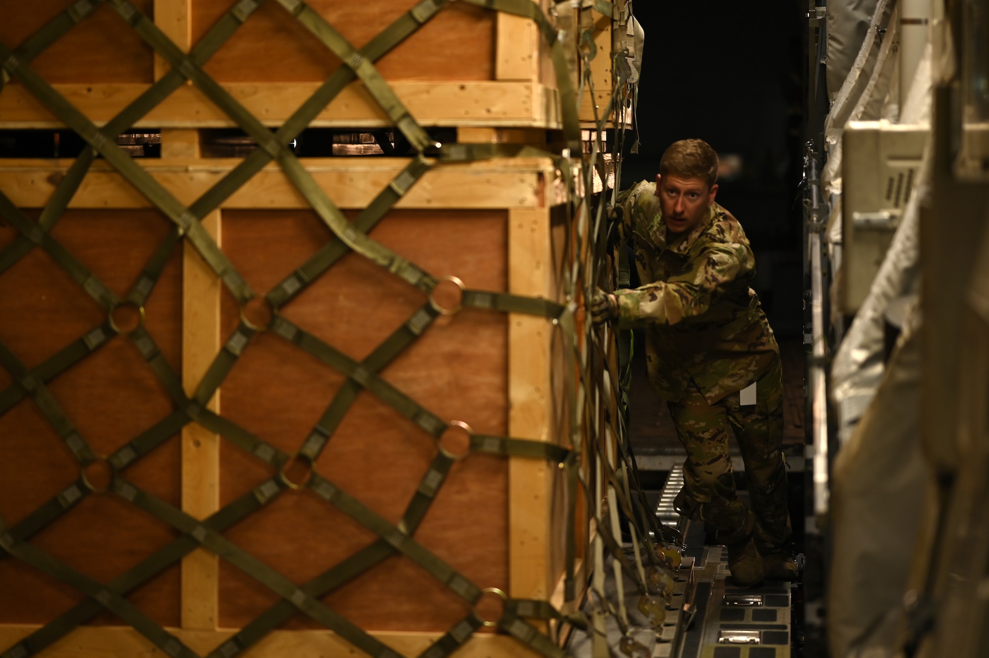 Staff Sgt. Nicholas Hartley, 8th Expeditionary Airlift Squadron loadmaster, loads humanitarian aid supplies onto a C-17 Globemaster III to provide international aid to Türkiye in the U.S. Central Command area of responsibility, Feb. 21, 2023.
The 8th EAS personnel airlifted more than 300,000 pounds of aid, providing humanitarian assistance in response to the devastating impacts in Türkiye following the worst earthquake to hit the region in almost a century. (U.S. Air Force photo by Staff Sgt. Gerald R. Willis)