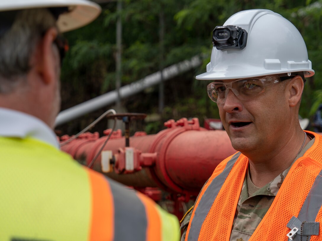 U.S. Army Maj. Stephen Buck, an engineering officer assigned to Joint Task Force-Red Hill (JTF-RH) speaks with a contractor at the Red Hill Bulk Fuel Storage Facility (RHBFSF) at Halawa, Hawaii, Feb. 22, 2023. Buck is one of approximately 60 engineers working to defuel the RHBFSF. (U.S. Air National Guard photo by Staff Sgt. Orlando Corpuz)