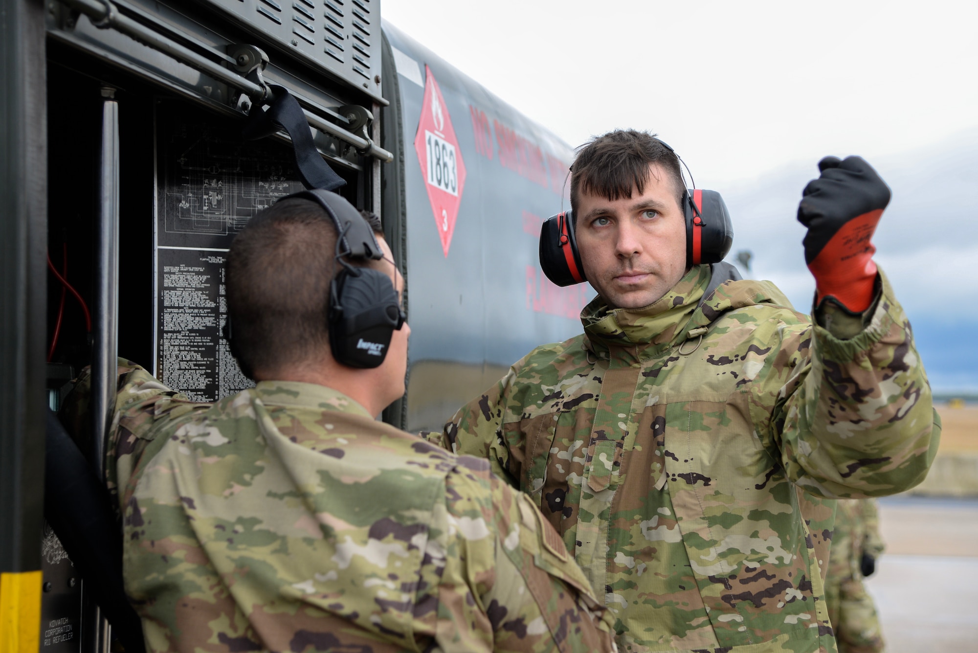 A photo of Tech. Sgt. Matthew Willard, with the 157 Logistics Readiness Squadron, Pease Air National Guard Base, being instructed on how to perform a hot-pit refuel of an F-16C+ Fighting Falcon by Tech. Sgt. Charles A. Zingrone, Jr., a 177th Logistics Readiness Squadron Fuels Management Flight fuels information service center section chief, during Integrated Combat Turnaround training.