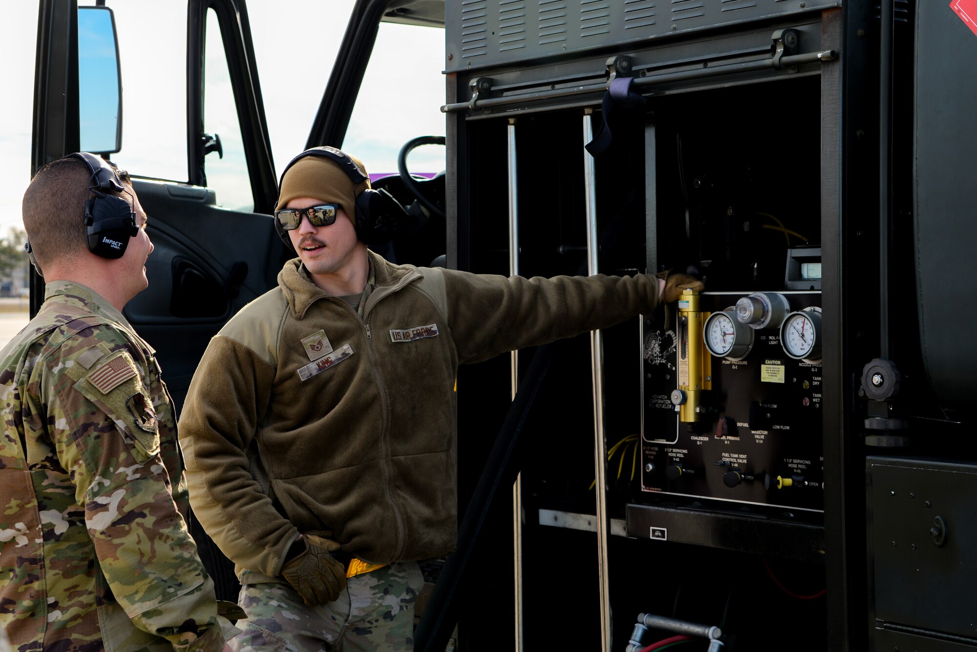 A photo of Staff Sgt. Johnathan King, 375th Logistics Readiness Squadron fuels management flight training non-commissioned officer in charge, being instructed how to perform a hot-pit refuel of an F-16C+ Fighting Falcon by Tech. Sgt. Charles A. Zingrone, Jr., 177th Logistics Readiness Squadron Fuels Management Flight fuels information service center section chief, during Integrated Combat Turnaround training.