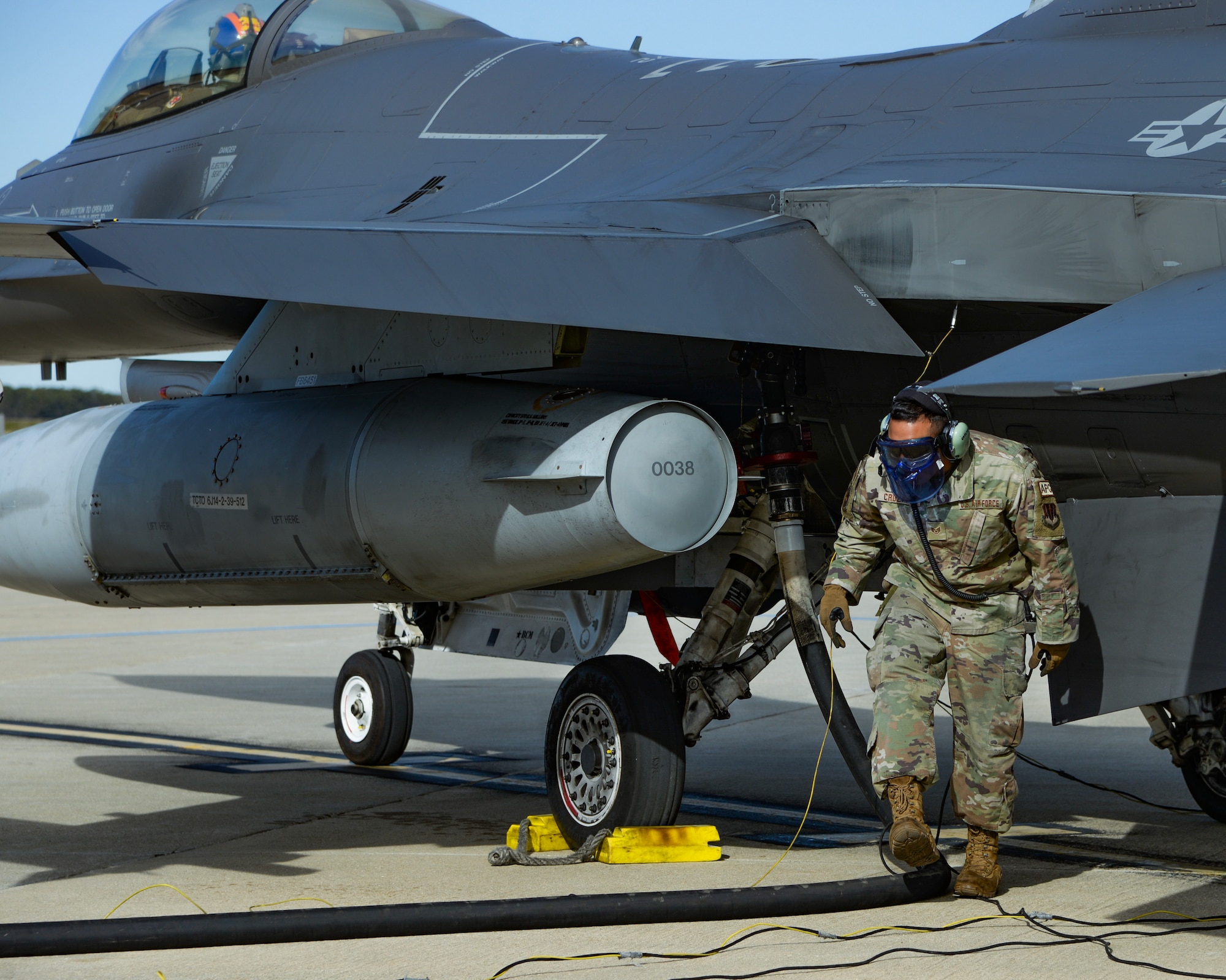 A photo of Staff Sgt. Dalbert Cruzado, 177th Aircraft Maintenance Squadron crew chief, refueling an F-16C+ Fighting Falcon during Integrated Combat Turnaround training.