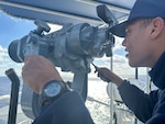U.S. Coast Guard Seaman Apprentice Greyson Collins, a crew member assigned to USCGC Vigilant (WMEC 617), searches for migrant vessels or vessels in distress throughout the Florida Straits Feb. 7, 2023. Vigilant is on a patrol in support of Operation Vigilant Sentry in the Caribbean Sea. (U.S. Coast Guard photo by Ensign Serheni’te Johnson)