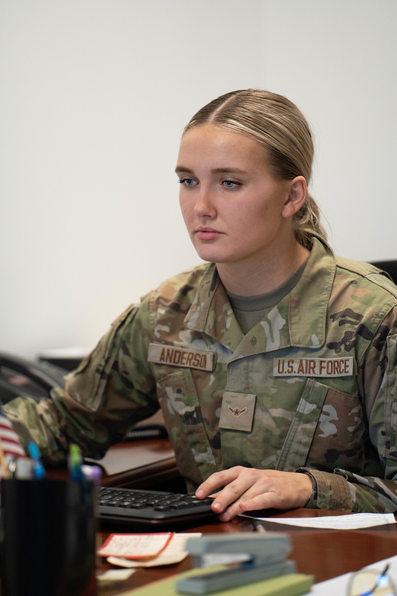 U.S. Air Force Airman 1st Class Ellie Anderson, a customer support apprentice assigned to the 114th Fighter Wing Logistics Readiness Squadron, works on fulfilling a customer’s request on the phone during February’s unit training assembly at Joe Foss Field, Feb. 25, 2023.