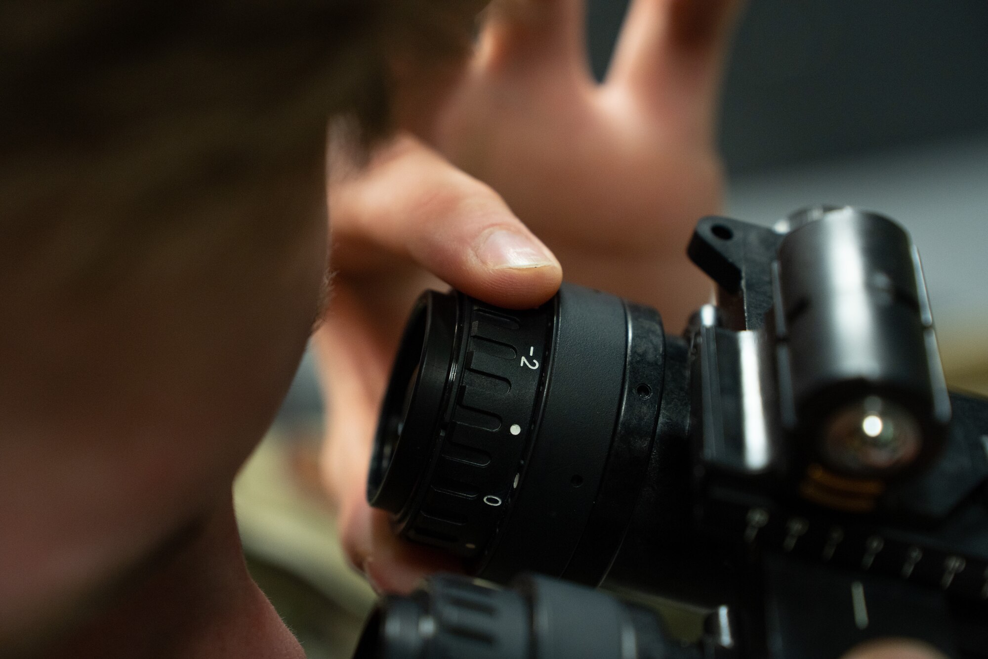 U.S. Air National Guard Staff Sgt. Kevin Larsgaard, aircrew flight equipment technician (AFE), 114th Fighter Wing, examines a pair of night vision goggles on Feb. 25, 2023, Joe Foss Field, South Dakota.
