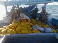 ARABIAN SEA (Feb. 25, 2023) Illicit drugs interdicted by USCGC John Scheuerman (WPC 1146) sit on the deck of a fishing vessel during an inventory by U.S. Coast Guard personnel operating in the Arabian Sea, Feb. 25, 2023.