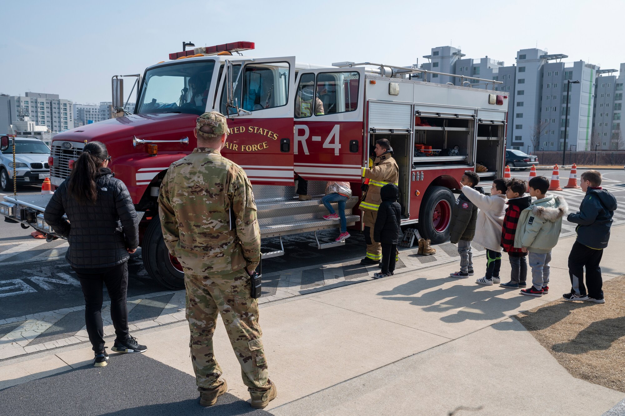 Students from Osan Elementary School tour a fire truck from the 51st Civil Engineer Squadron at Osan Air Base, Feb. 17, 2023. U.S. Air Force firemen from the 51st CES brought the truck out as part of the school’s career day, which showcased different jobs in and outside of the Air Force. (U.S. Air Force photo by Senior Airman Trevor Gordnier)