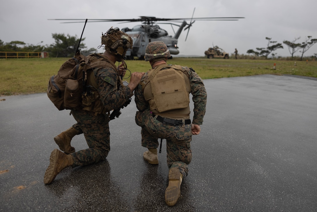 U.S. Marines with 3d Battalion, 4th Marines coordinate with CH-53E Super Stallion pilots for an air insertion during Jungle Warfare Exercise 23 in the Northern Training Area on Okinawa, Japan, Feb. 14, 2023. JWX 23 is a large-scale field training exercise focused on leveraging the integrated capabilities of joint and allied partners to strengthen all-domain awareness, maneuver, and fires across a distributed maritime environment. (U.S. Marine Corps photo by Cpl. Lorenzo Ducato)