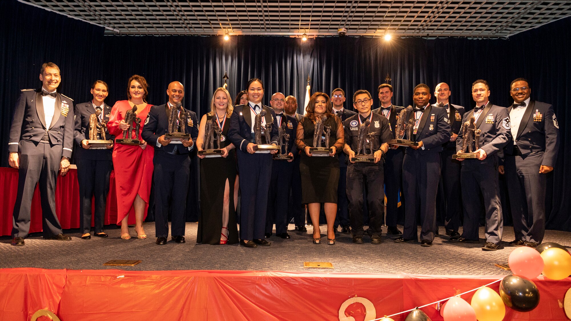 U.S. Air Force Col. Andrew Roddan, 374th Airlift Wing commander, and 374th AW Command Chief Master Sgt. Jerry Dunn, pose for a group photo with winners of the 2023 Annual Awards Ceremony at Yokota Air Base, Japan, Feb. 24, 2023.