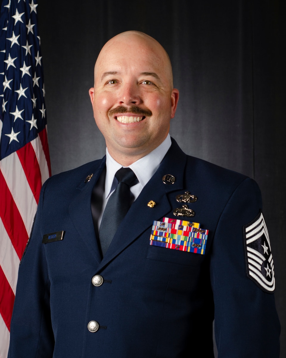 Chief Master Sgt. Kevin Reiter official photo with U.S. flag.
