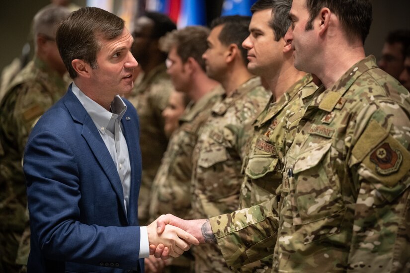 Kentucky Gov. Andy Beshear congratulates members of the Kentucky Air National Guard’s 123rd Special Tactics Squadron after awarding the Kentucky Governor’s Outstanding Unit Citation to the squadron’s Airmen during Leadership Development Day at the Kentucky Exposition Center in Louisville, Ky., Feb. 5, 2023. The award recognizes the unit’s rescue efforts following tornadoes and flooding that struck the Commonwealth in 2021 and 2022. The Airmen cleared 140,000 square feet of rubble at a collapsed factory, evacuated 40 flood victims and recovered four missing children. (U.S. Air National Guard photo by Dale Greer)