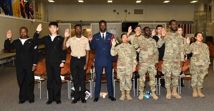 Eleven service members accept the Oath of allegiance during a Certificate of Naturalization ceremony