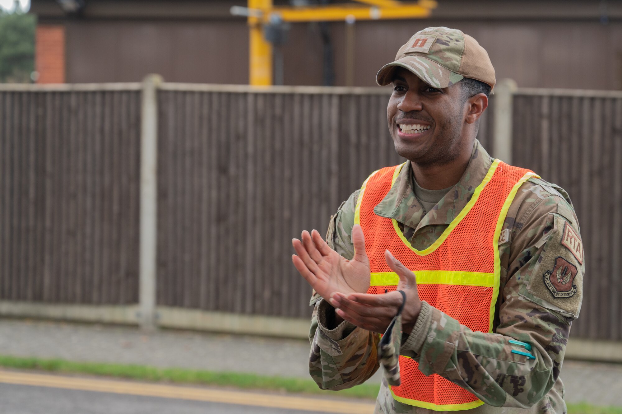 U.S. Air Force  Chaplain (Capt.) Benjamin Mattocks, 100th Air Refueling Wing, cheers on participants during the Black History Month 5K run and walk, Feb. 23, 2023, at Royal Air Force Mildenhall, England.