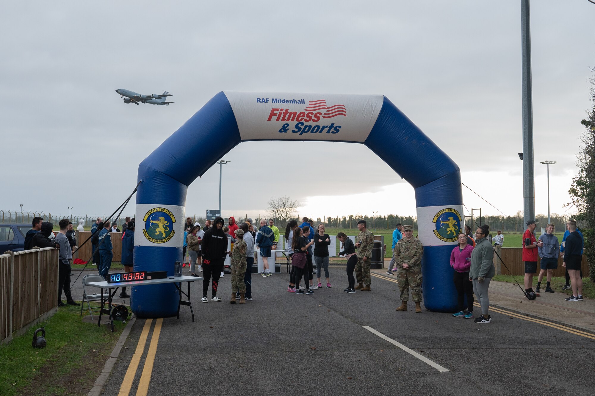 U.S. Air Force service members, spouses and family, stand at the finish line of the Black History Month 5K run and walk, Feb. 23, 2023, at Royal Air Force Mildenhall, England.