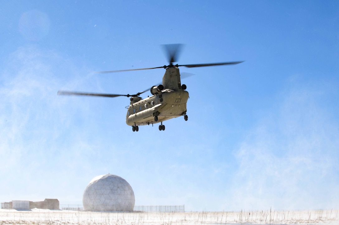 A helicopter takes off in a desert.