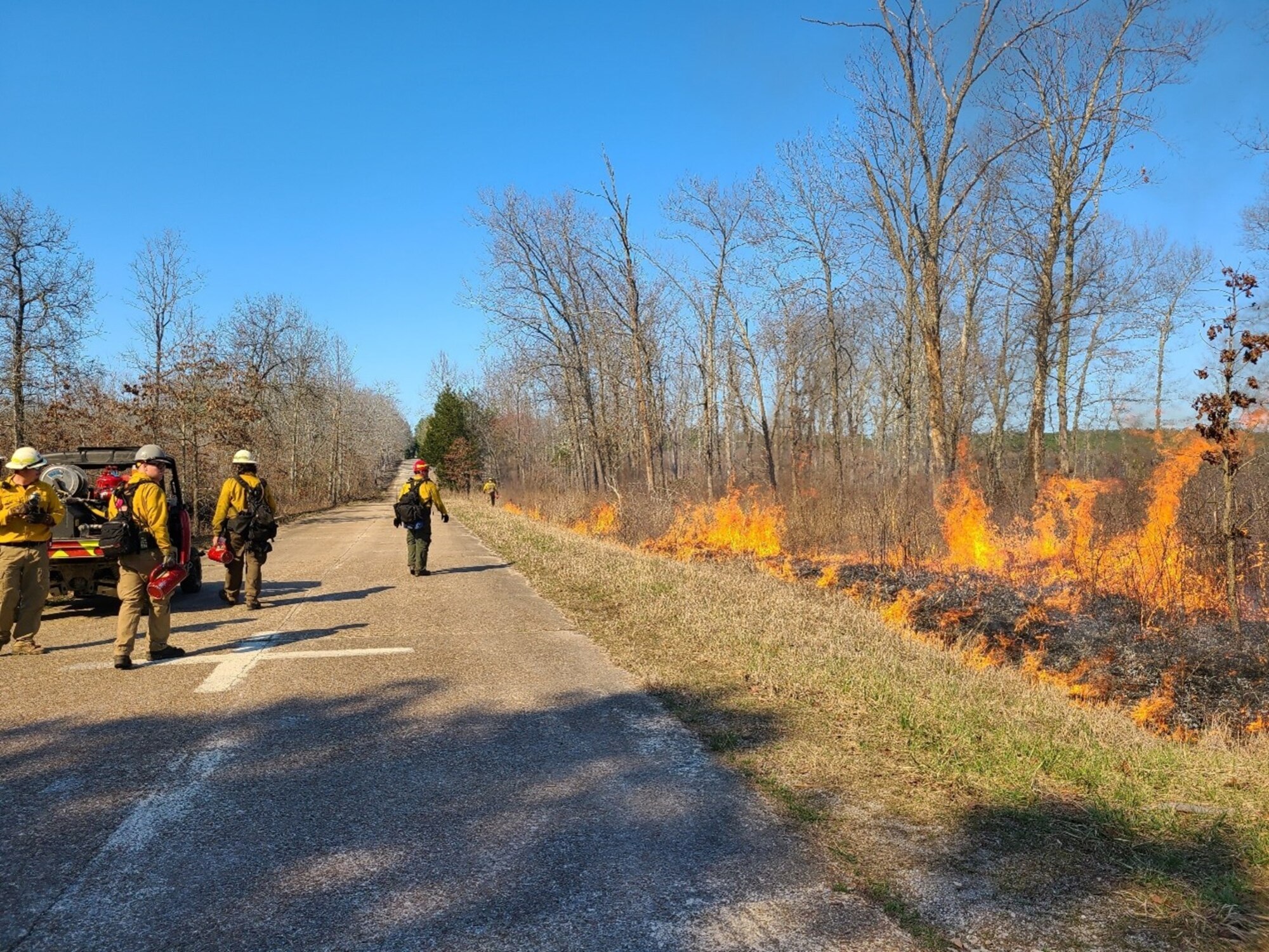 Crews monitor a previous prescribed fire, or controlled burn, at Arnold Air Force Base, Tennessee, in spring 2021. This spring, the natural resources staff at Arnold Air Force Base will work with the Air Force Wildland Fire Branch to conduct prescribed fires across Arnold. Prescribed fire allows land managers to alter and improve the native ecosystems without utilizing more costly methods such as mulching, mowing and herbicide applications. (Courtesy photo by Brenton Berlin)