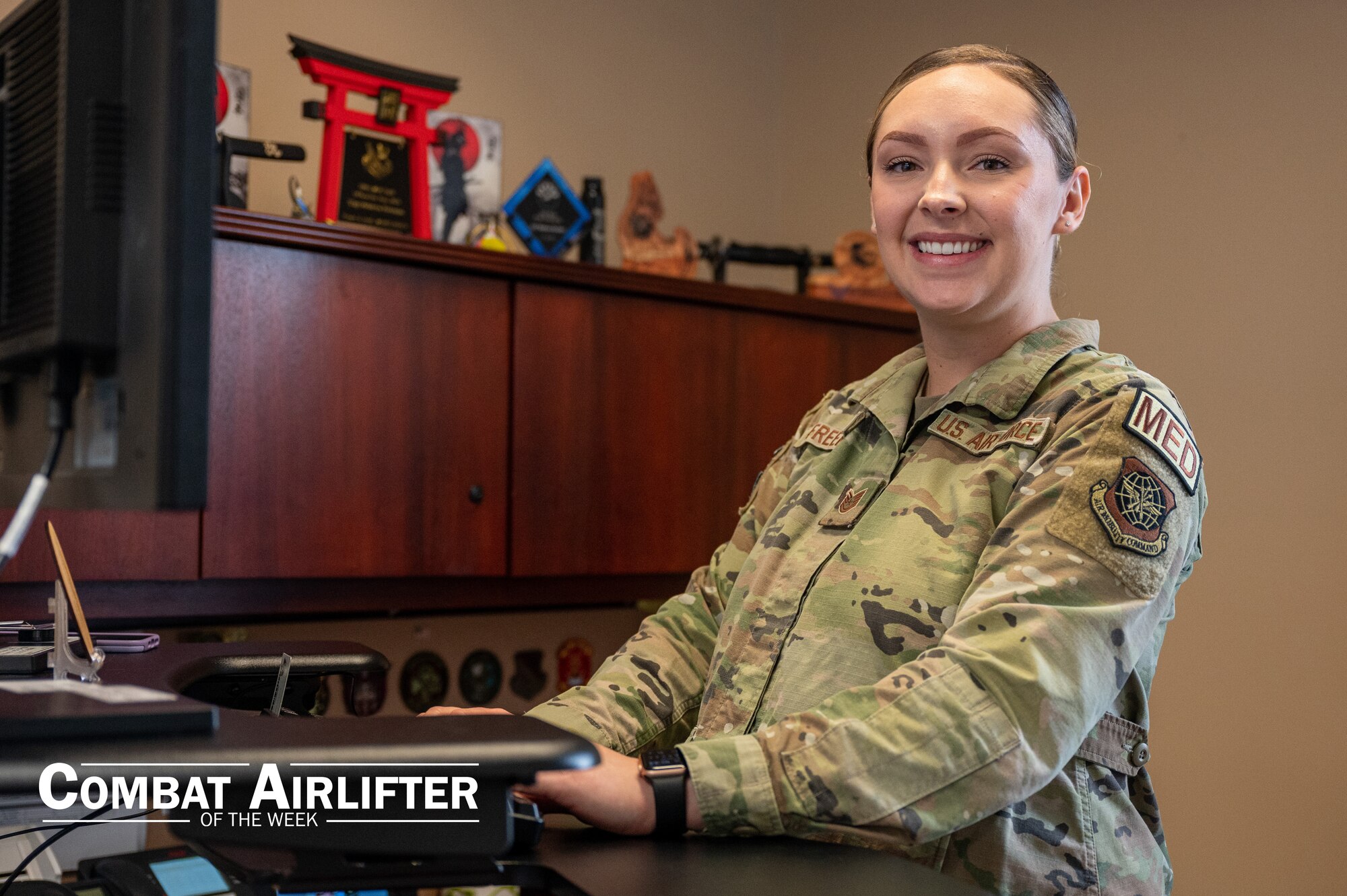 A woman in uniform poses for a photo