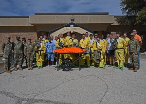 Medical members from Dyess Air Force Base and Goodfellow AFB pose for a photo after the in-place patient decontamination exercise, Goodfellow Air Force Base, Texas, Feb. 23, 2023. The members achieved their time objectives by reaching mission capable status in 6 minutes 21 seconds and reaching fully operational status in 9 minutes 10 seconds. (U.S. Air Force Photo by Airman 1st Class Zachary Heimbuch)