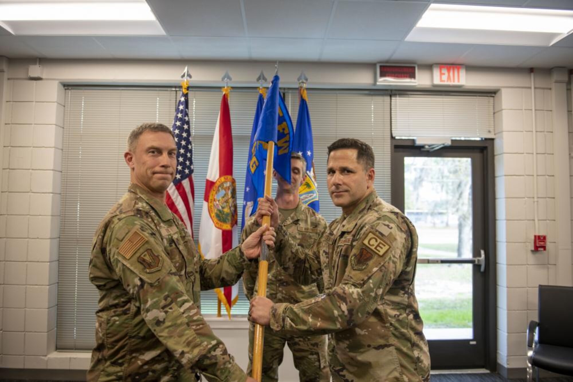 U.S. Air Force Col. George Downs, 125th Fighter Wing commander, passes the 125th Regional Support Group guidon to Col. Brian Vitetta, 125th RSG commander, at the activation ceremony for the 125th RSG held at Camp Blanding Joint Training Center in Starke, Florida, Feb. 24, 2023. The 125th RSG activated Jan. 15, 2023, under the 125th Fighter Wing, Florida Air National Guard. The group encompasses the 202nd Rapid Engineer Deployable Heavy Operational Repair Squadron Engineer (RED HORSE), 290th Joint Communications Support Squadron, 159th Weather Flight and 131st Training Flight. The formation postures the 125 FW for greater warfighting capability and increased readiness to meet the strategic threats of today and tomorrow. (U.S. Air National Guard photo by Tech Sgt. Chelsea Smith)
