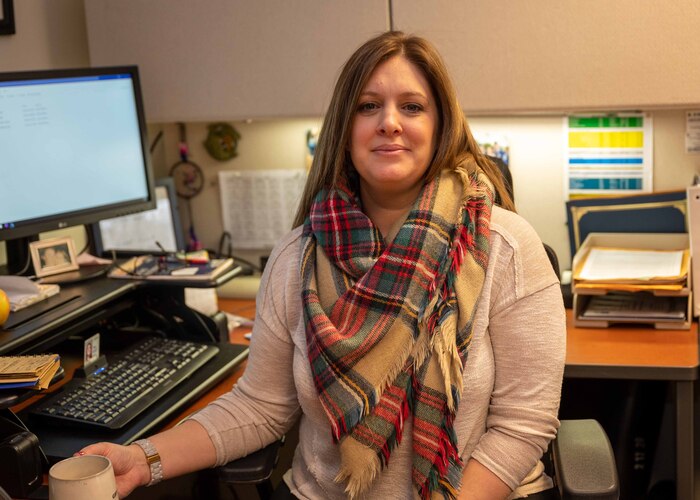 Gina Johnson, 934th Force Support Squadron education services specialist, poses for a picture in the education and training office at Minneapolis-St. Paul Air Reserve Station on Feb. 4, 2022. Johnson helps service members with a variety of educational benefits. (U.S. Air Force Photo by Senior Airman Matthew Reisdorf)