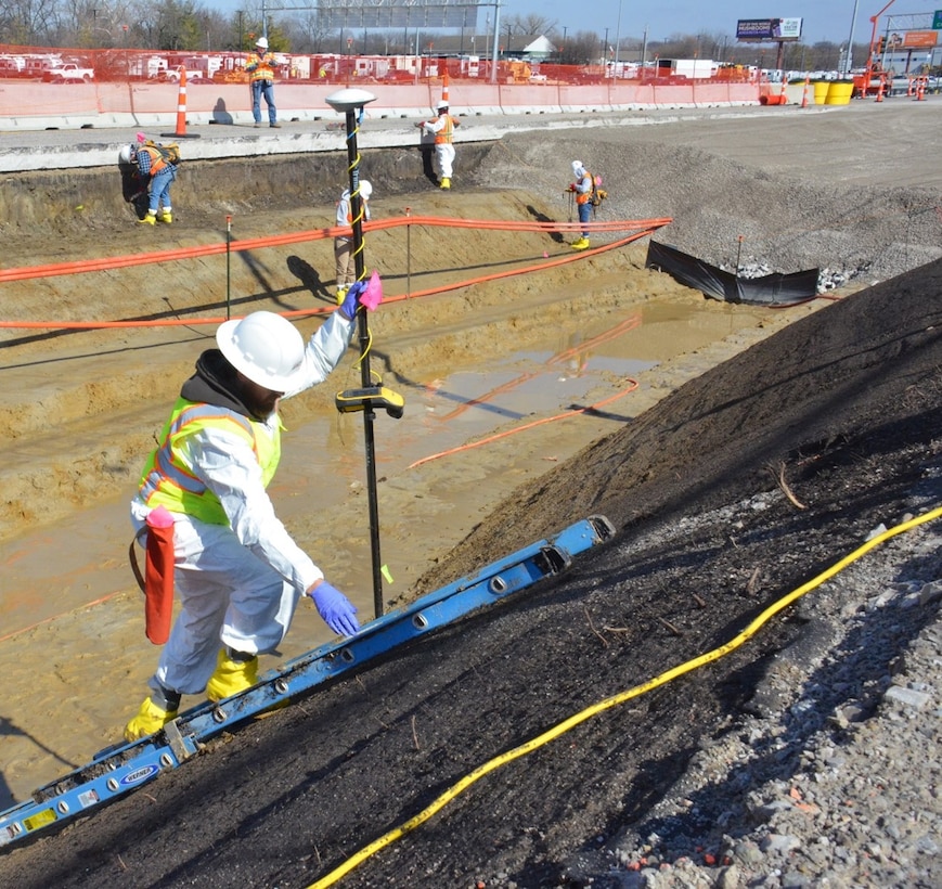 A United States Army Corps of Engineers Formerly Utilized Sites Remedial Action Program contractor uses a GPS device to mark verification sample locations in a remediated strip of Pershall Road in Hazelwood, Missouri to verify remediation was completed successfully.  The FUSRAP team’s ability to initiate remediation activities on Pershall Road was enabled by an ongoing partnership with the Missouri Department of Transportation, who notifies the team of roadwork that makes previously inaccessible soils available for sampling, testing and remediation.  The U.S. Army Corps of Engineers remains actively engaged in activities to address community concerns about radioactive material along Coldwater Creek and will continue to prioritize the health and well-being of the community, guided by data-driven decisions.