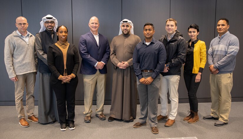 U.S. Army Soldiers with the 18th Financial Support Center join members of the National Bank of Kuwait in a group photo during a key leader engagement in Kuwait City, Kuwait, Jan. 25, 2023. The engagement concentrated on new capabilities to provide operational flexibility in funding the U.S. Central Command theater. (U.S. Army photo by Spc. Cecilia Soriano)