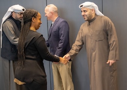 18th Financial Support Center Director Col. Kevin Pierce (center) shakes hands with National Bank of Kuwait Assistant General Manager Hamad Al-Shakhs (far left) as Sgt. Maj. Stephanie Ellis (left) shakes hands with NBK Relationship Officer Talal Q. Yousef AlQatami (far right) during a key leader engagement in Kuwait City, Kuwait, Jan. 25, 2023. The engagement concentrated on new capabilities to provide operational flexibility in funding the U.S. Central Command theater. (U.S. Army photo by Spc. Cecilia Soriano
