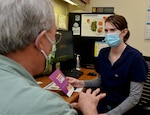 Pharmacist talks to patient