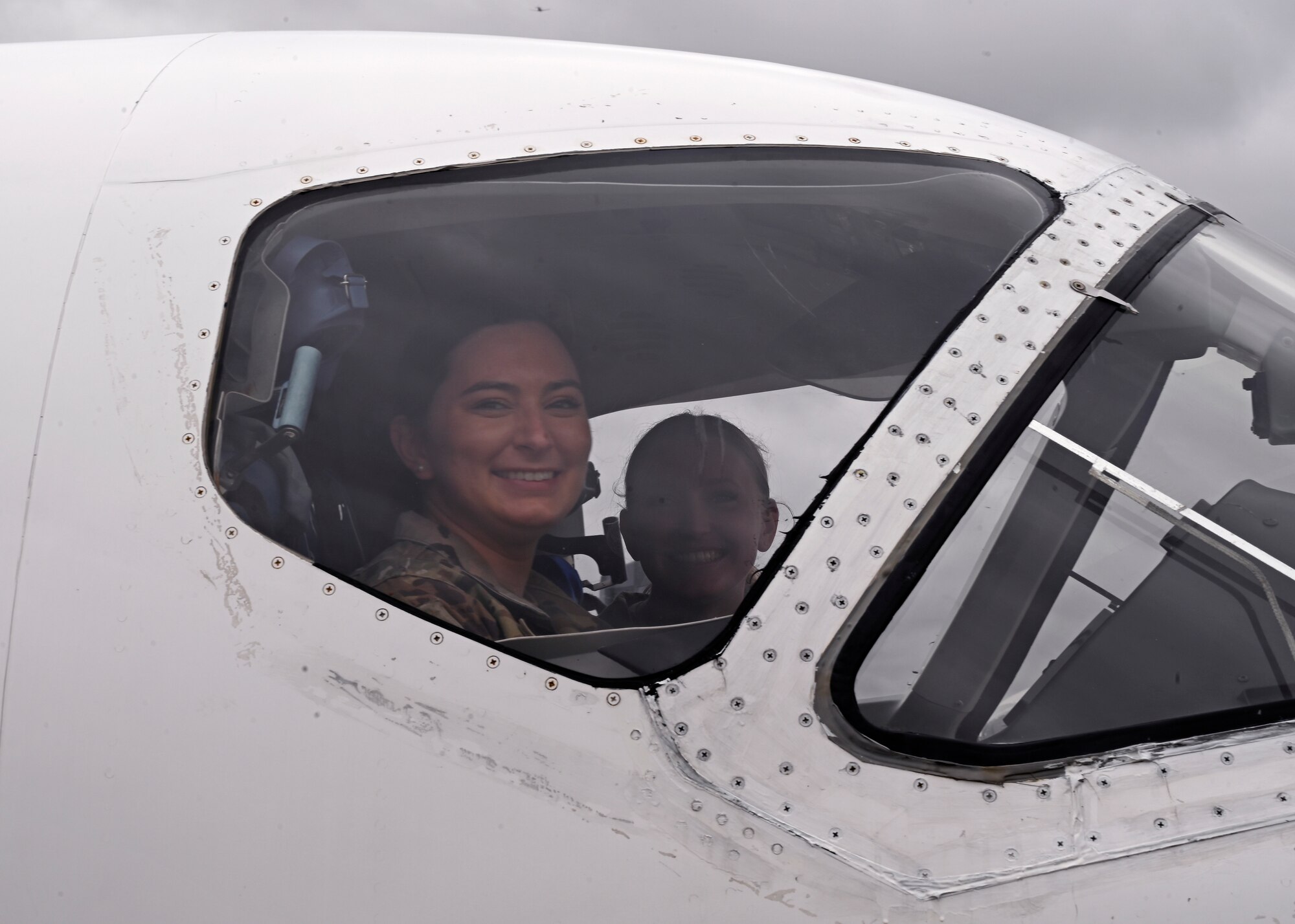 U.S. Air Force Tech. Sgt. Casaadi Bubois, left, 627th Force support Squadron NCO in charge of career development and Airman 1st Class Erika Weatherly, 62d Comptroller Squadron budget analyst, sit in the cockpit of a T-1 aircraft at Columbus Air Force Base, Miss., Feb. 15, 2023. Team McChord Airmen toured Columbus AFB and gained first-hand experience of their mission: Produce Pilots, Advance Airmen, Feed the Fight. (U.S. Air Force photo by Senior Airman Callie Norton)