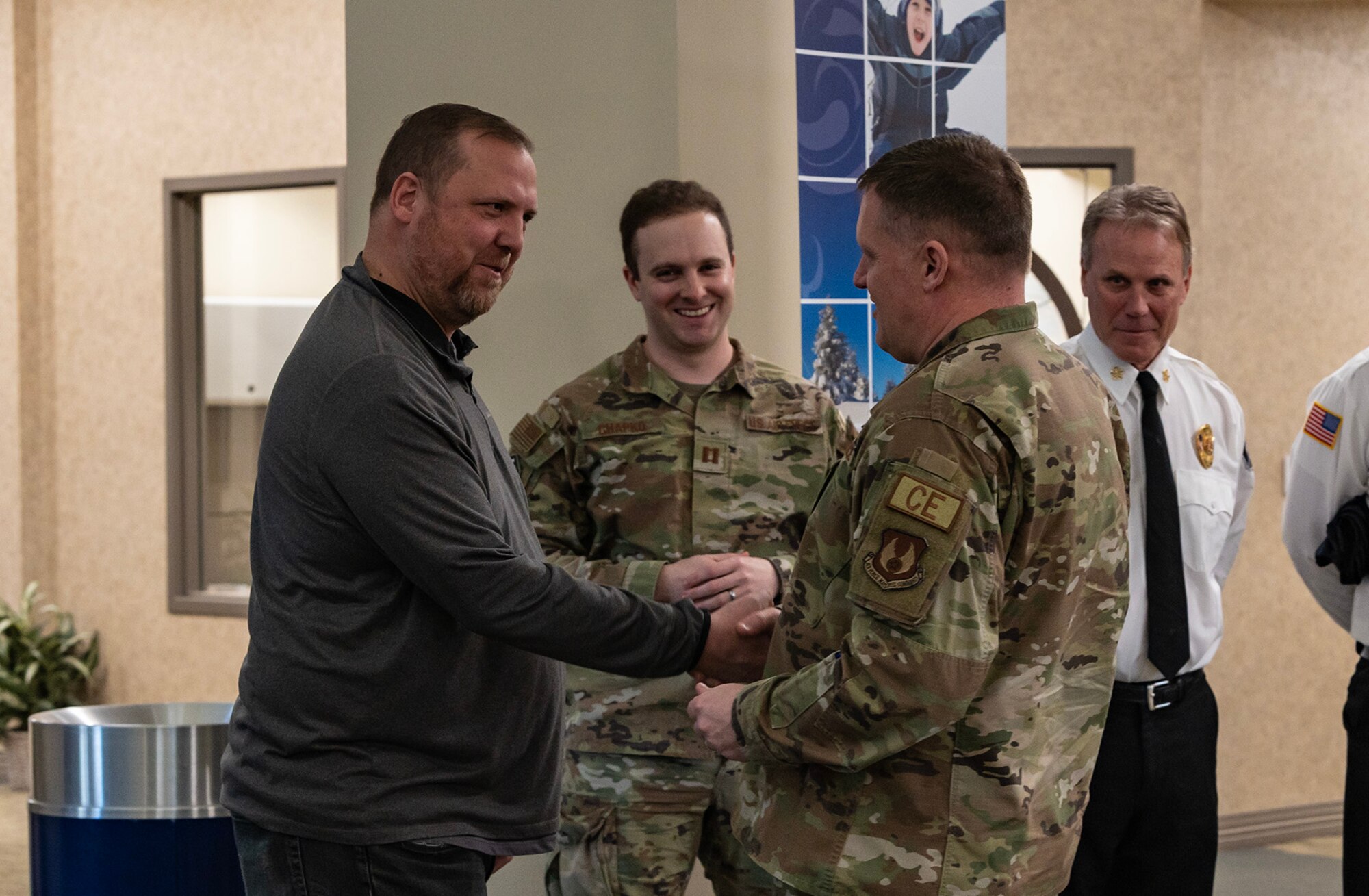Two men shake hands.