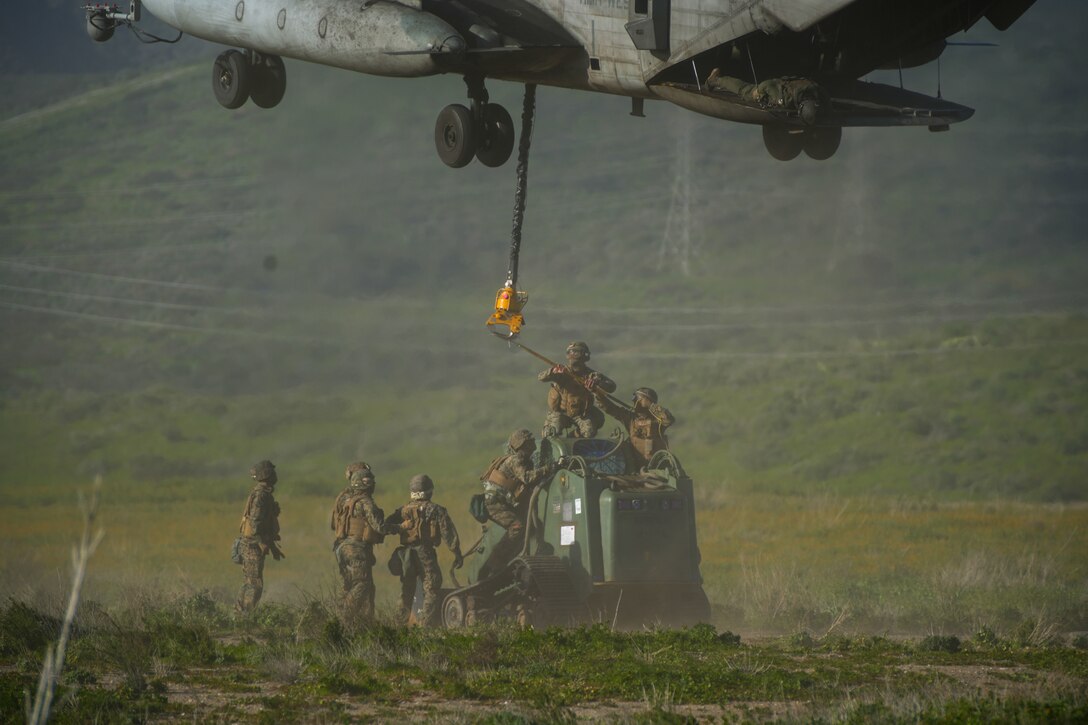 U.S. Marines assigned to Combat Logistics Battalion 15, Combat Logistics Regiment 17, 1st Marine Logistics Group, prepare to sling load equipment beneath a CH-53E Super Stallion attached to Marine Heavy Helicopter Squadron (HMH) 361, Marine Aircraft Group 16, 3rd Marine Aircraft Wing, during helicopter support team training as part of CLB-15’s Marine Corps Combat Readiness Evaluation (MCCRE) at Marine Corps Base Camp Pendleton, California, Jan. 25, 2023. The purpose of CLB-15’s MCCRE is to evaluate the unit's ability to perform assigned mission essential tasks in preparation for a future deployment. (U.S. Marine Corps photo by Sgt. Sydney Smith)