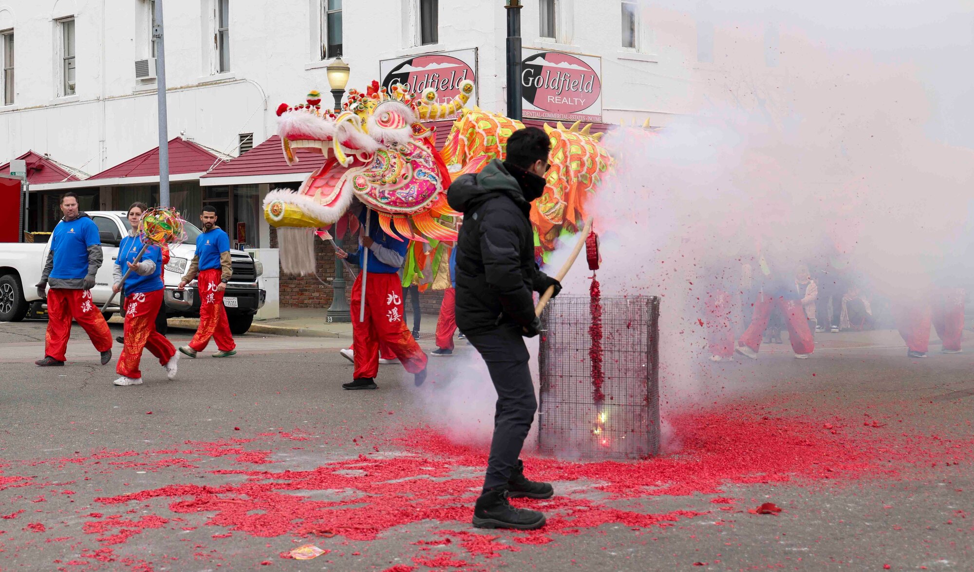 A member of the Marysville Chinese community lights fireworks for the dragon “Hong Wan Lung”, held by Airmen from Beale Air Force Base, Calif., to dance around during the 143rd Bok Kai parade on Feb. 25, 2023 in Marysville, Calif.