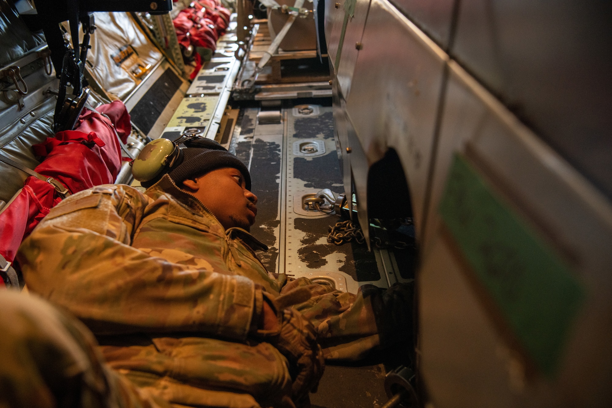 A U.S. Air Force Airman secures cargo on an aircraft