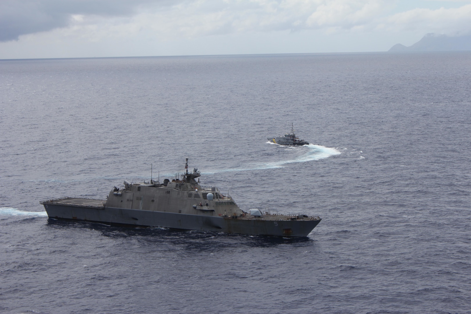 The Freedom-variant littoral combat ship USS Milwaukee (LCS 5) and Dutch Caribbean coast guard vessel Poema (P812) conduct a bilateral exercise off the coast of Sint Maarten, Netherlands Feb. 22.