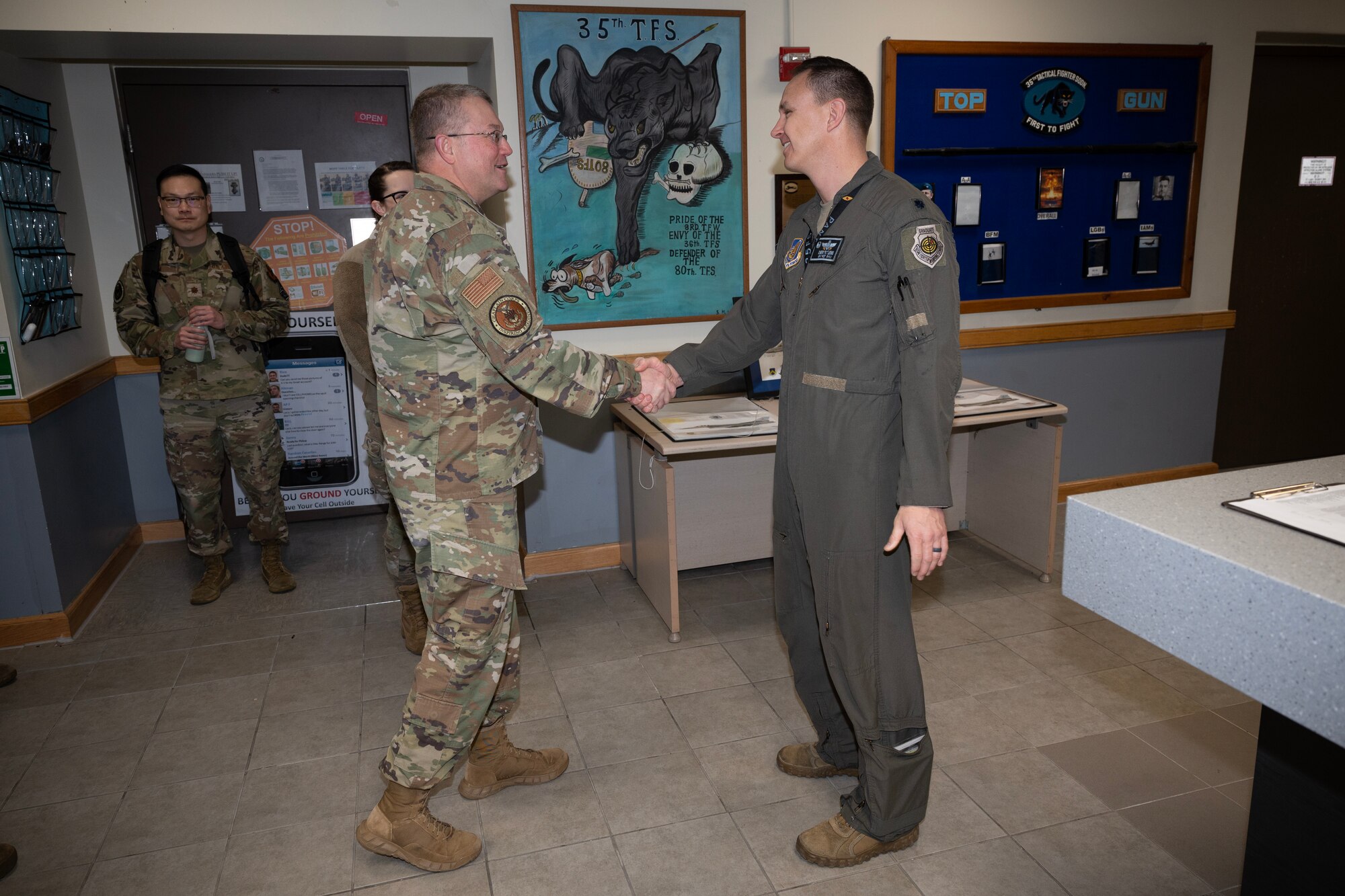 U.S. Air Force Ch. (Maj. Gen.) Randall Kitchens (right), Department of the Air Force chief of chaplains, shakes the hand of Lt. Col. Brian Lewis, 35th Fighter Squadron commander, at Kunsan Air Base, Republic of Korea, Feb. 23, 2023. During his time at Kunsan, Kitchens was assigned as the chaplain of the 35th FS and went by the call sign “Chappie.” (U.S. Air Force photo by Senior Airman Akeem K. Campbell)