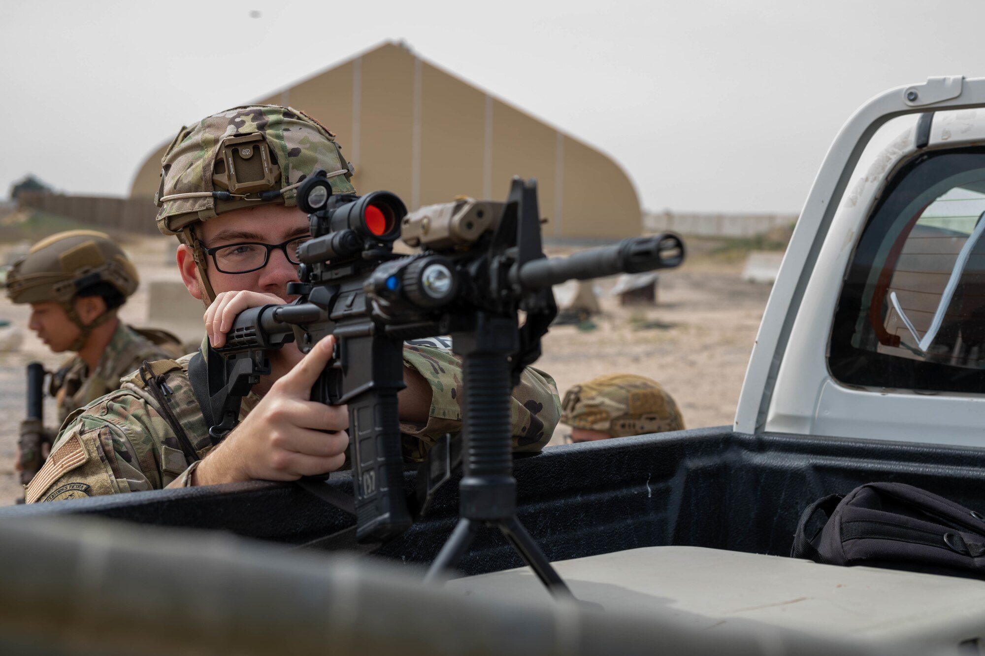 U.S. Air Force Airman 1st Class Johnny Reed, a 386th Expeditionary Security Forces Squadron defender, keeps watch over a downed mock Unmanned Aircraft System during a UAS response exercise at Ali Al Salem Air Base, Kuwait, Feb. 21, 2023.