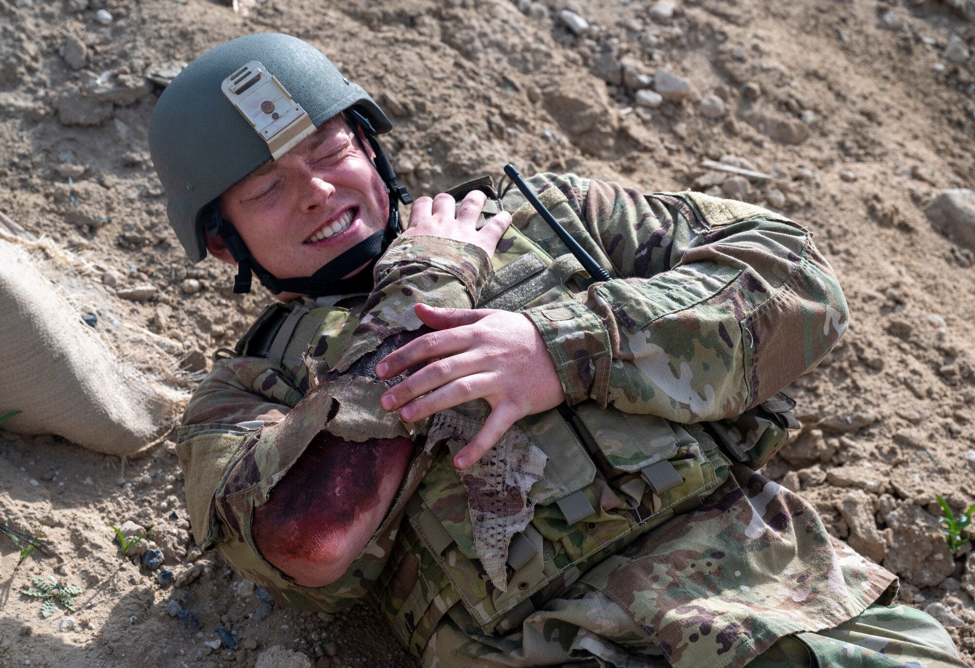U.S. Air Force Senior Airman Dillon James, a 386th Expeditionary Logistics Readiness Squadron fuels operator, simulates being burned during an Unmanned Aerial System response exercise at Ali Al Salem Air Base, Kuwait, Feb. 21, 2023.