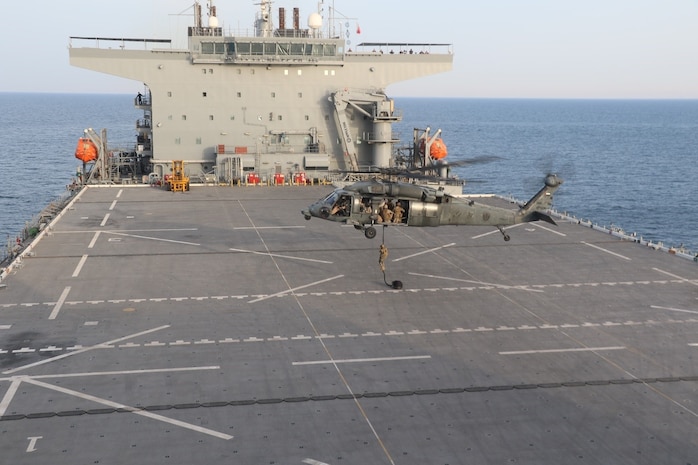 ARABIAN GULF (Feb. 22, 2023) Members of the United Arab Emirates Armed Forces depart a UH-60M Black Hawk during deck landing qualifications aboard expeditionary sea base USS Lewis B. Puller (ESB 3) in the Arabian Gulf, Feb. 22, 2023. Puller is deployed to the U.S. 5th Fleet area of operations to help ensure maritime security and stability in the Middle East region.