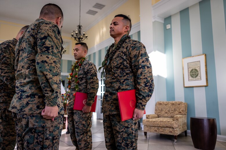 U.S. Marine Corps Warrant Officer Steve Asher, a utilities officer with 1st Combat Engineer Battalion, 1st Marine Division, rear, and Staff Sgt. Jerry Tolenoa , a Marine Corps Community Services officer with Marine Corps Base Hawaii Kaneohe Bay, front right, stand at attention during their pinning ceremony to warrant officer on Marine Corps Base Quantico, Virginia, Feb. 1, 2023. The Ambassador of the Federated States of Micronesia to the United States, family and friends attended the promotion ceremony of Asher and Tolenoa who joined the Marine Corps from the Federated States of Micronesia. (U.S. Marine Corps photo by Lance Cpl. Joaquin Dela Torre)