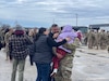 A Soldier from the 485th Engineer Company hugs his Family members Feb. 14 after a nine-month deployment to Kuwait.