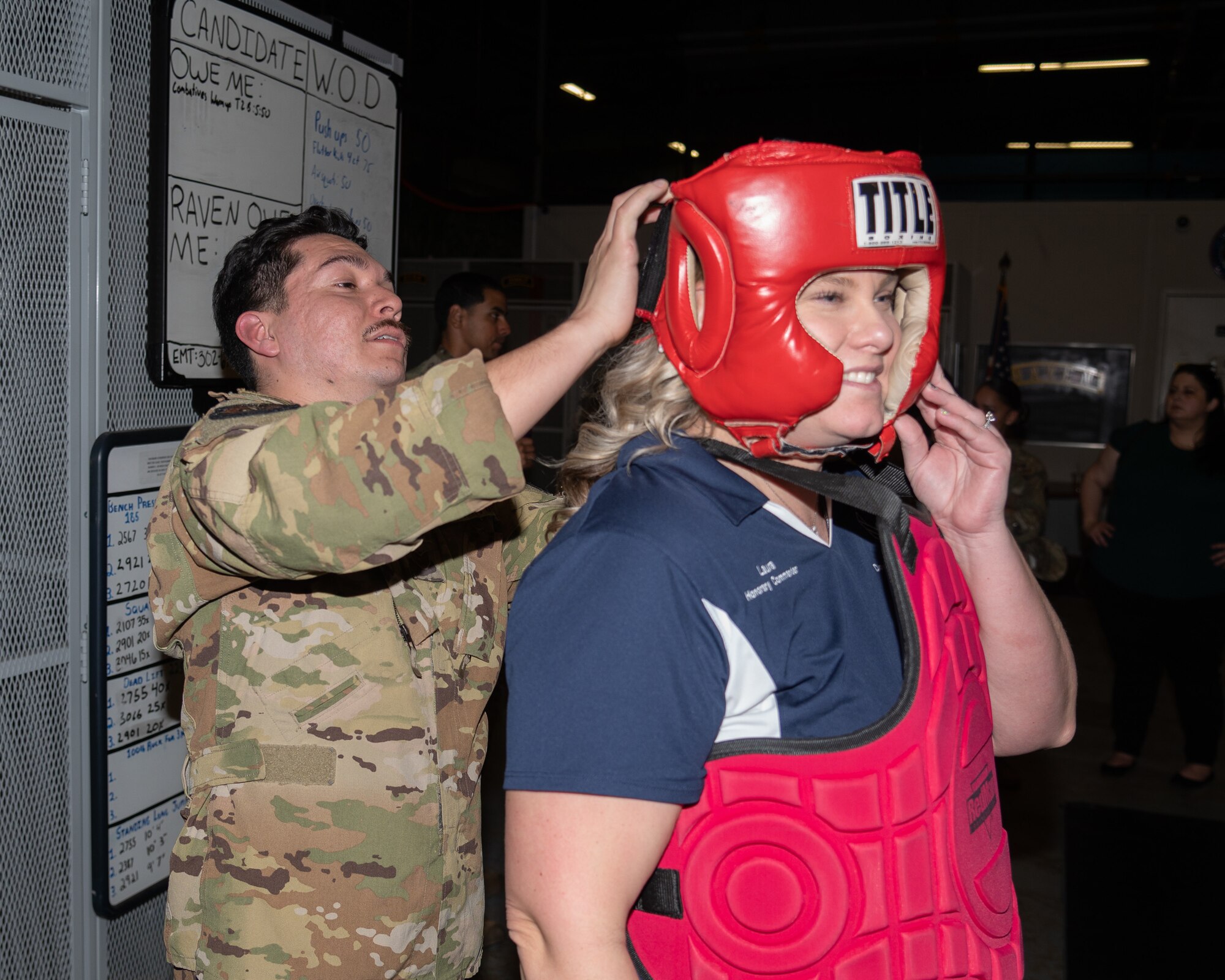 Laura Garofoli, Air Force Medical Examiner System honorary commander, dons protective gear during an immersion tour on Dover Air Force Base, Delaware, Feb. 23, 2023. Established in 1992, the HCC program is a community outreach effort that builds upon the great relationships between local civic leaders and Dover AFB personnel. (U.S. Air Force photo by Mauricio Campino)