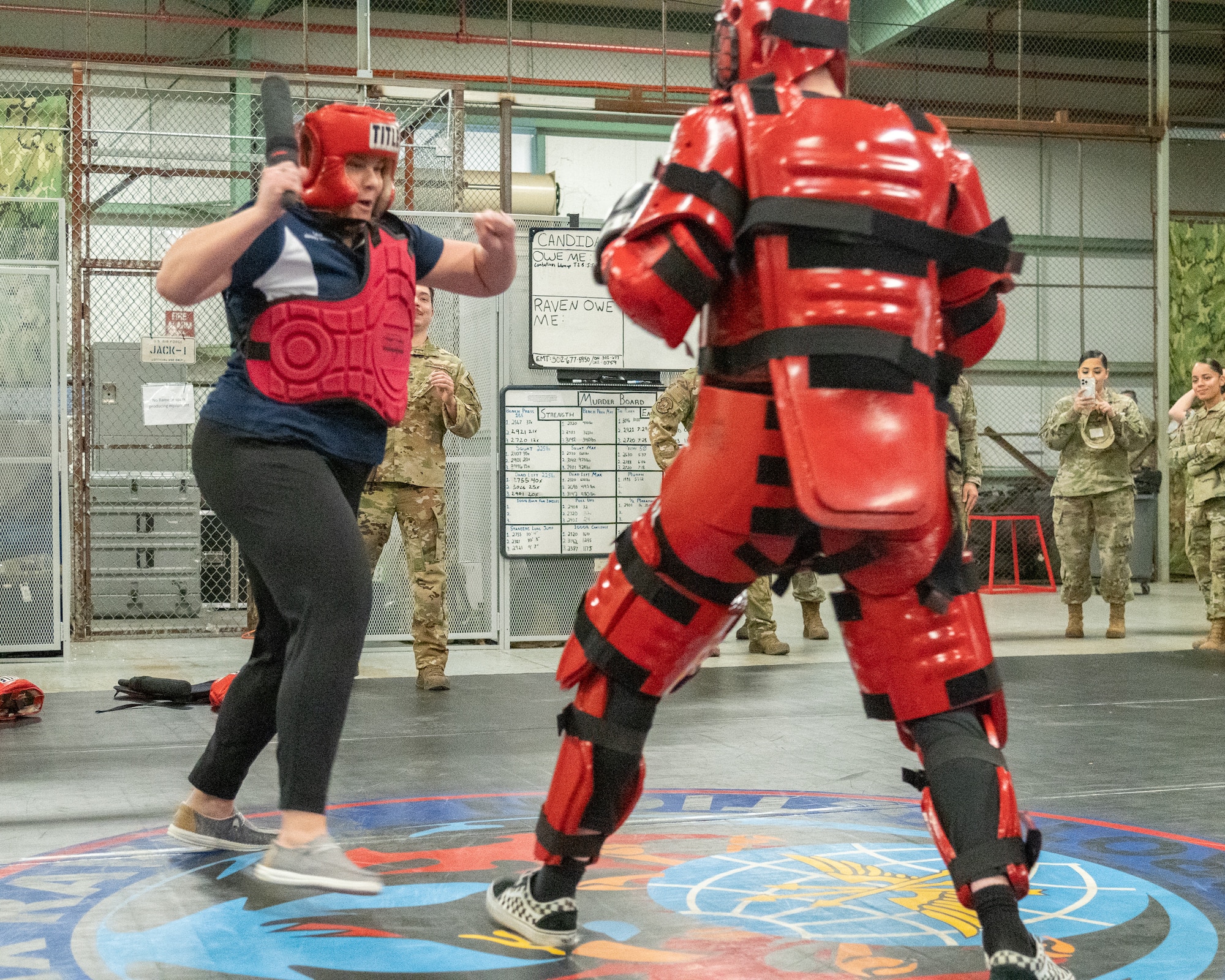 Laura Garofoli, Air Force Medical Examiner System honorary commander, fends off a 436th Security Forces Squadron Phoenix Raven team member in a training suit during an immersion tour on Dover Air Force Base, Delaware, Feb. 23, 2023. Honorary commanders toured the base and met with Airmen from various squadrons to familiarize themselves with the Team Dover mission. (U.S. Air Force photo by Mauricio Campino)