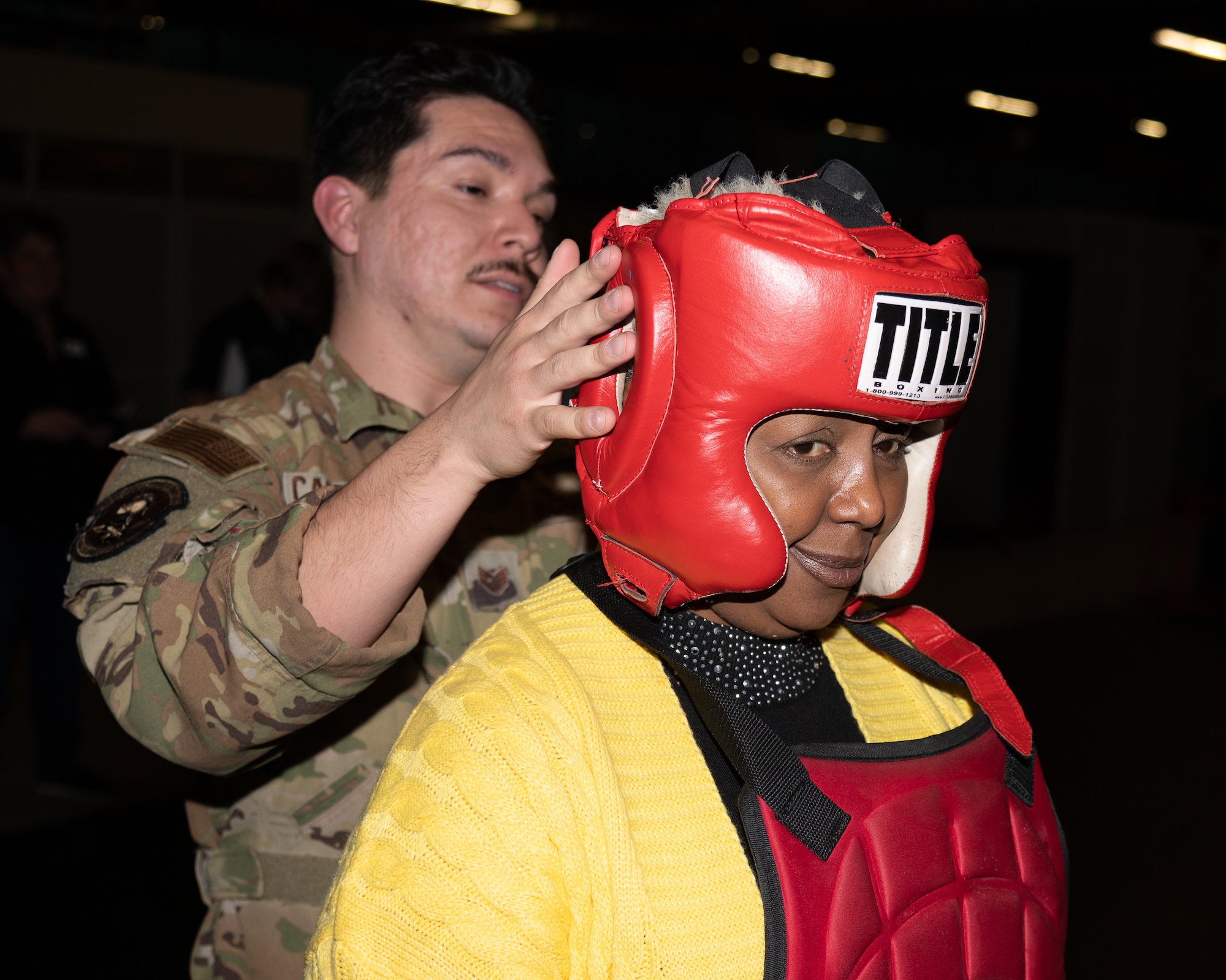 Dr. Eunice Gwanmesia, 436th Airlift Wing honorary commander, dons protective gear during an immersion tour on Dover Air Force Base, Delaware, Feb. 23, 2023. Established in 1992, the HCC program is a community outreach effort that builds upon the great relationships between local civic leaders and Dover AFB personnel. (U.S. Air Force photo by Mauricio Campino)